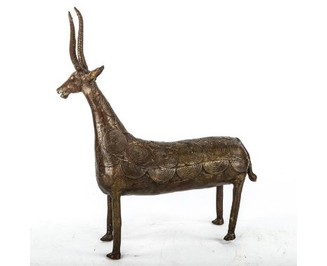 An African Tribal bronze antelope with applied disc designs to the body, overall height 34cm 