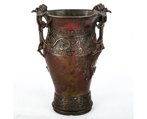 A Chinese Ming Dynasty patinated bronze vase, with dragon decorated handles and impressed bands, height 19cm 
