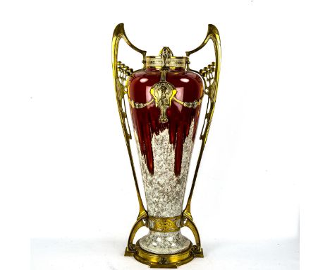 A large Austrian secessionist vase, red high fire treacle glaze ceramic in Art Nouveau cast-brass casing, impressed no. 9081 
