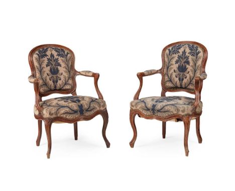 PAIR OF LOUIS XV WALNUT AND NEEDLEWORK FAUTEUILS MID 18TH CENTURY the cartouche shaped backs over wide stuffover seats and pa