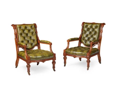PAIR OF VICTORIAN CARVED OAK AND LEATHER LIBARY ARMCHAIRS 19TH CENTURY the sloping button upholstered backs above deep seats 
