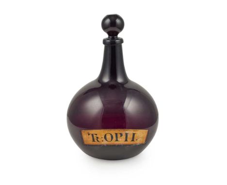 LARGE AMETHYST GLASS PHARMACY OPIUM BOTTLE AND STOPPER 19TH CENTURY of onion form, inscribed in black ‘TR:OPII’ on a gilt gro
