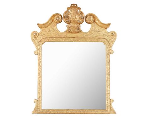 GEORGE II GILTWOOD EASEL MIRROR EARLY 18TH CENTURY the rectangular mirror plate in a foliate carved frame surmounted by a swa