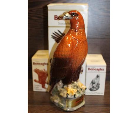 BENEAGLES CERAMICGOLDEN EAGLE DECANTER
in original boxes and still with contents, 28cm high; together with four Beneagles min