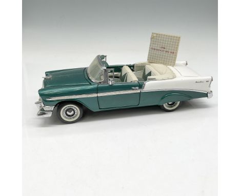 Metal replica of this classic convertible. Colored in green and white with moveable doors, hood and trunk. Franklin Mint tag.