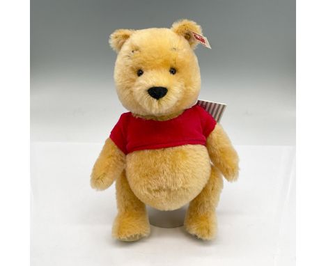 The iconic yellow bear in a red crop top with moveable arms, legs and head. Steiff tag attached. Dimensions: 6.25"L x 3.75"W 