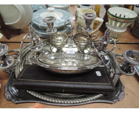 A selection of silver plated items including two butler trays, lidded tureen, pair of three sconce candelabrum of squat form,