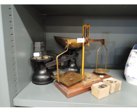 A selection of weighing scales and various cast weight sets 