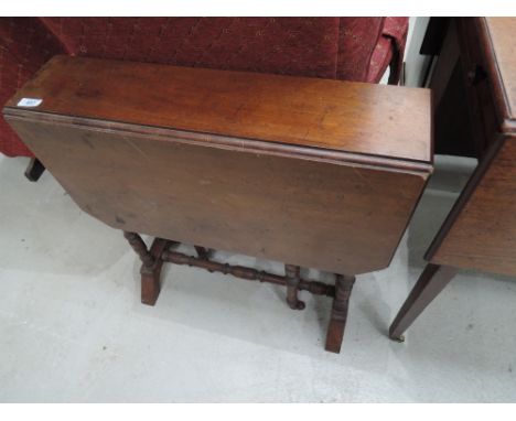 A early 20th century mahogany sutherland table of traditional design on ring turned legs