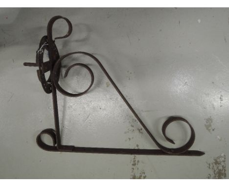 A cast and wrought iron wall or gas light bracket