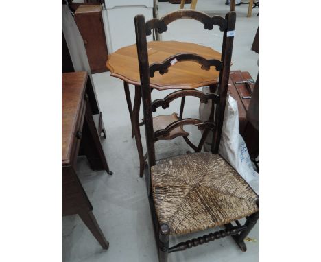 An early 20th century stained frame rocking chair having crest ladder back with rush seat and bobbin stretcher 