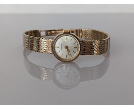 A ladies mid-century Longines manual dress watch in a 9ct gold case and bi-gold strap, hallmarked, baton markers, dial 14mm, 