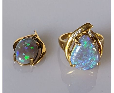 An Australian black opal ring in an 18ct yellow gold claw setting with diamond decoration, 15 x 12mm, size Q and a matching o