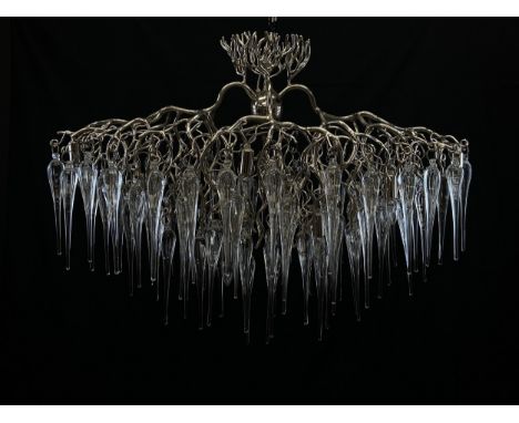 A contemporary 'Hollywood Glass' chandelier having a naturalistic polished nickel tree branch superstructure over a waterfall