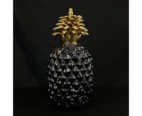 An early to mid 20th century Art Deco style ceramic lamp in the form of a gloss black pineapple with a gilt plume of fronds. 