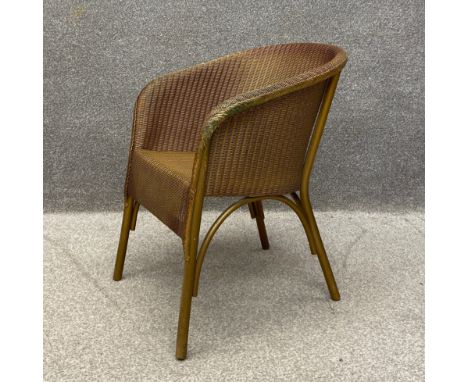 An early 20th century 'Lusty' wicker chair having a gold coloured painted finish by Lloyd Loom with a maker's plaque to the r