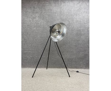 A contemporary industrial style floor standing lamp with a large shade on tripod supports. H.142cm