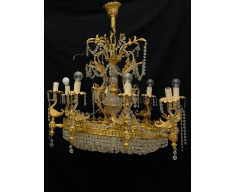 A 20th century Neoclassical style chandelier having a stacked globular cut glass stem within a scrolling foliate openwork cag