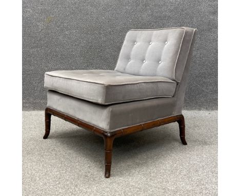 A 20th century 'Slipper' style chair having a square cushioned button back and seat upholstered in grey velour raised on a ca