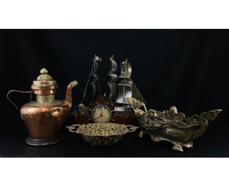 A collection of four metal items to include an Art Deco mantle clock in the form of a wooden ship with polished sheet metal s