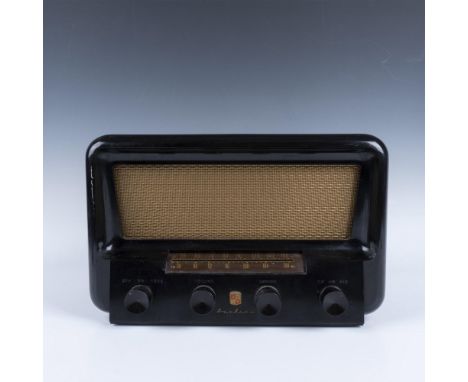 A sleek black radio with a striking gold speaker and four elegant tuning knobs for precise control. Montgomery Ward marked. A