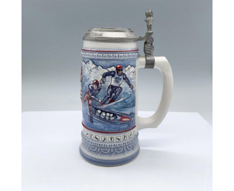 A ceramic drinking vessel with a pewter lid celebrating the competition and team in various winter sports taking place in Alb