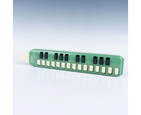 Unique wind musical instrument with horn end and piano keys. Exterior plastic case colored in green. Hohner Melodica Soprano 