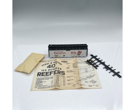 HO scale model train. White Carnation Milk train car comes with parts to assemble and instructions. This item has its origina