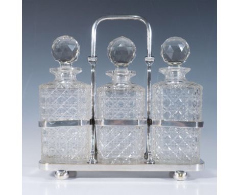 Beautiful set of cut crystal decanters with faceted stoppers in their carrying silver plated caddy. Marked 3362 on base. Cadd