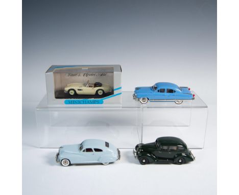 Die-cast metal with plastic parts, 1:43 scale replicas of vintage automobiles. First is a Paul's Model Art Minichamps BMX 507