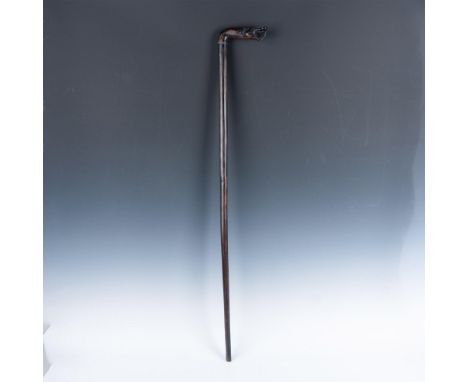 Dark wood walking stick with the handle carved as a serpentine-dragon. Dimensions: 5.5"L x 1"W x 38"HCondition: Age related w