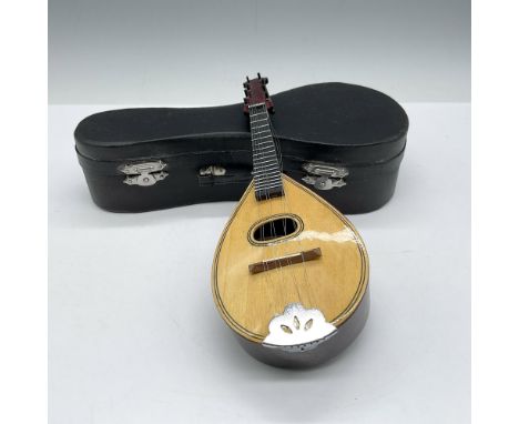 Unique styled music box with wind up on back. Mandolin plays Eine Kleine Nachtmusik. Leather case included. Issued: 20th cent
