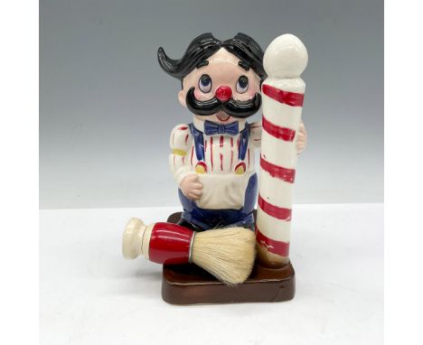 Playful caddy designed with old time barber standing next to his pole. Caddy holds soap and brush with a space for razors. Is