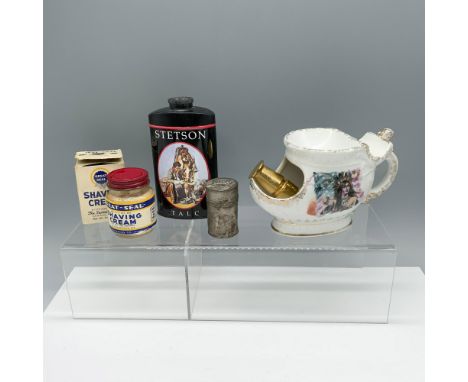 Pleasing collection of products used to shave that includes: a ceramic shaving mug decorated with a person in headgear in fro