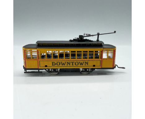 This is a highly detailed trolly car in HO scale with yellow sides with red detail and black top. It is marked Downtown on th
