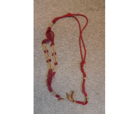A HUSSAR OFFICER'S BARREL SASH  Narrow crimson cords with a woven gold collar at each end, a gold olivet at one end, and thre