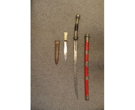 AN AFRICAN DAGGER AND A BURMESE DHA, LATE 19TH/20TH CENTURY the first with leaf-shaped blade, elliptical iron guard, faceted 