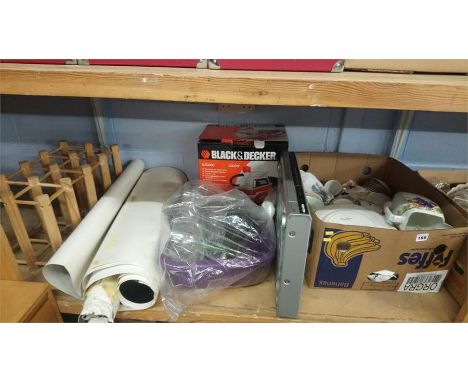 Shelf of assorted posters and DVD player etc.