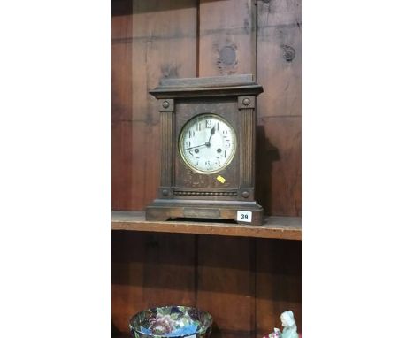 An oak cased mantel clock