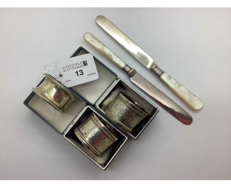 A Pair of Victorian Hallmarked Silver Napkin Rings, London 1883, of decorative foliage panel design, together with another ha