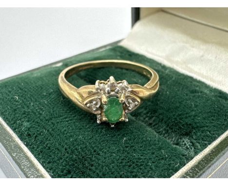 A 9ct Gold Diamond and Stone Set Cluster Ring, of flowerhead design, the oval centre stone four claw set between diamond surr