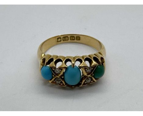 An 18ct Gold Victorian Style Turquoise Ring, the graduated cabochon set stones with inset highlights, within openwork setting