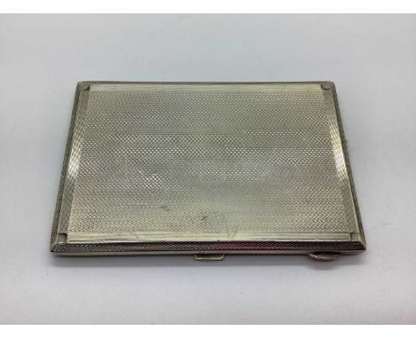 A Hallmarked Silver Cigarette Case, JR, Birmingham 1935, of rectangular form with allover engine turned design and gilt wash 