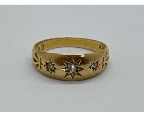 An Antique 18ct Gold Three Stone Diamond Ring, the graduated brilliant cut stones within starburst setting (finger size O) (3