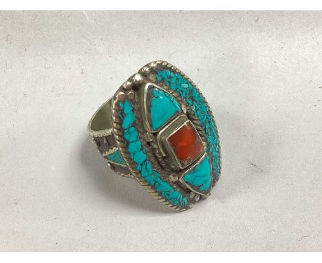 A Traditional Style Stone Set Ring, the rectangular centre stone collet set between trillian shaped accents, within a mosaic 