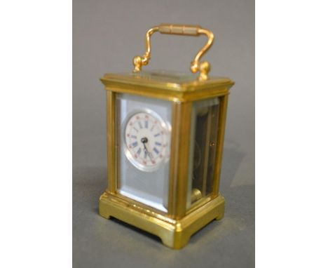 A French Brass Cased Carriage Clock, the silvered and enamel dial with Roman and Arabic numerals and with lever escapement an