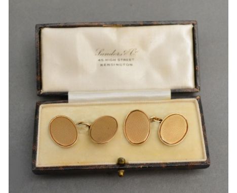 A Pair of 9ct. Gold Cufflinks with engine turned decoration within fitted case 