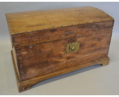 A Studded Pine Domed Chest, the hinged top above a brass lock plate, raised upon bracket feet, 61cms wide, 39cms deep, 37cms 