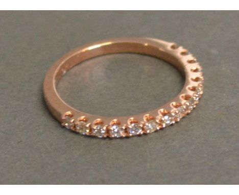 A 9ct. Rose Gold Half Eternity Diamond Ring, approximately 0.35 ct 