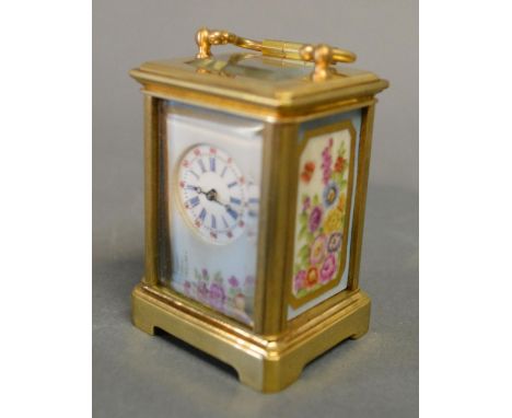 A Miniature French Brass Cased Carriage Clock with Porcelain Panels, the circular enamel dial with Roman and Arabic numerals 